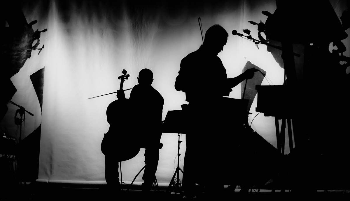 person silhouette of musicians playing black-and-white