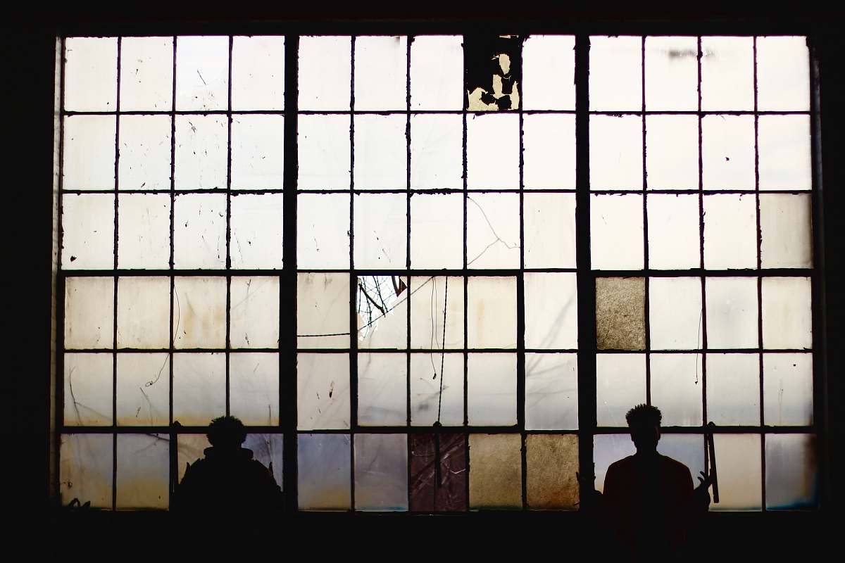person silhouette of people standing near window people