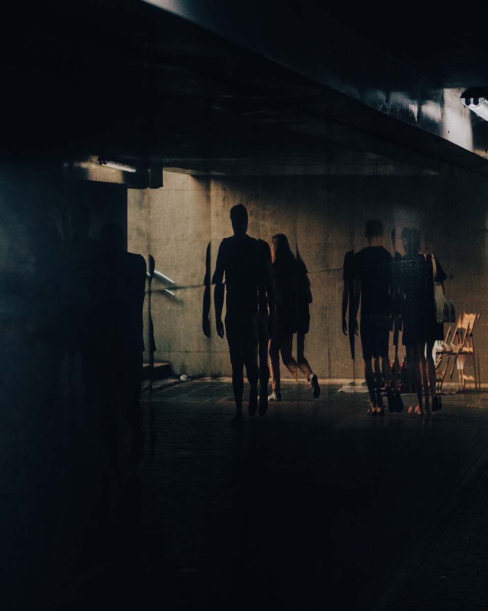 person silhouette of people walking near building pedestrian