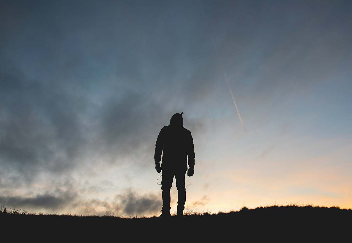 person silhouette of person across clouds silhouette