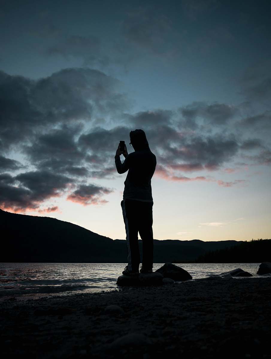 person silhouette of person near body of water people
