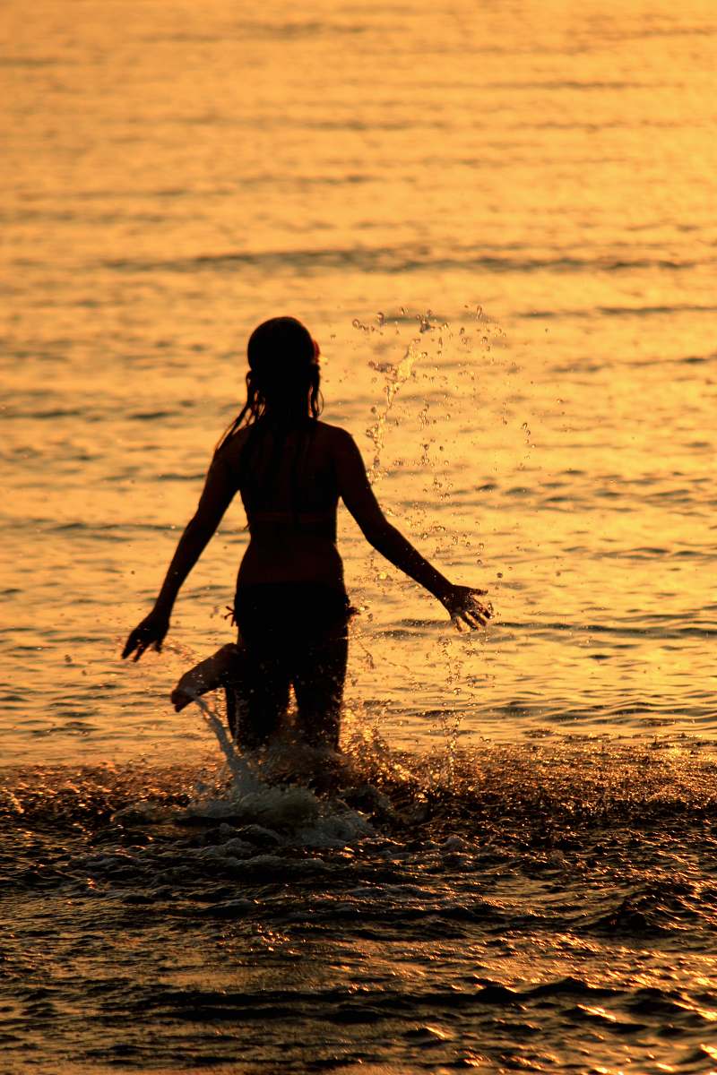 person silhouette of person on water during golden hour back