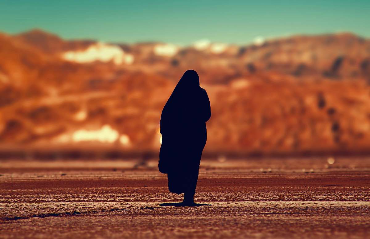 person silhouette of person walking on ground at daytime people