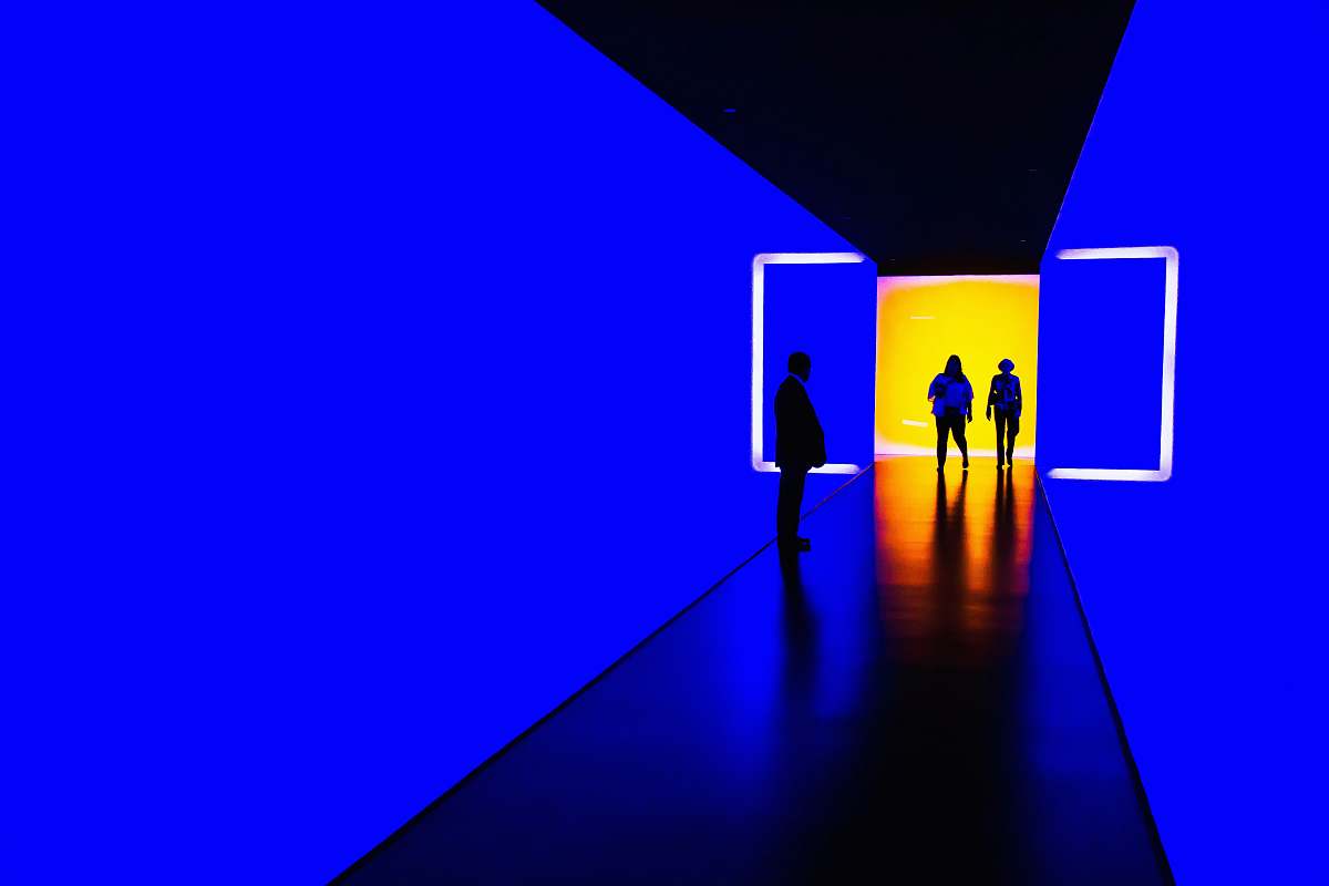person three person standing near wall inside building silhouette