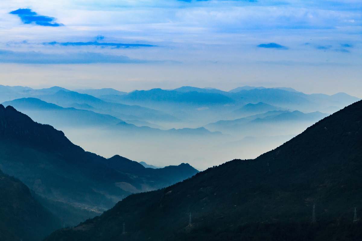 blue green mountain under blue sky clouds