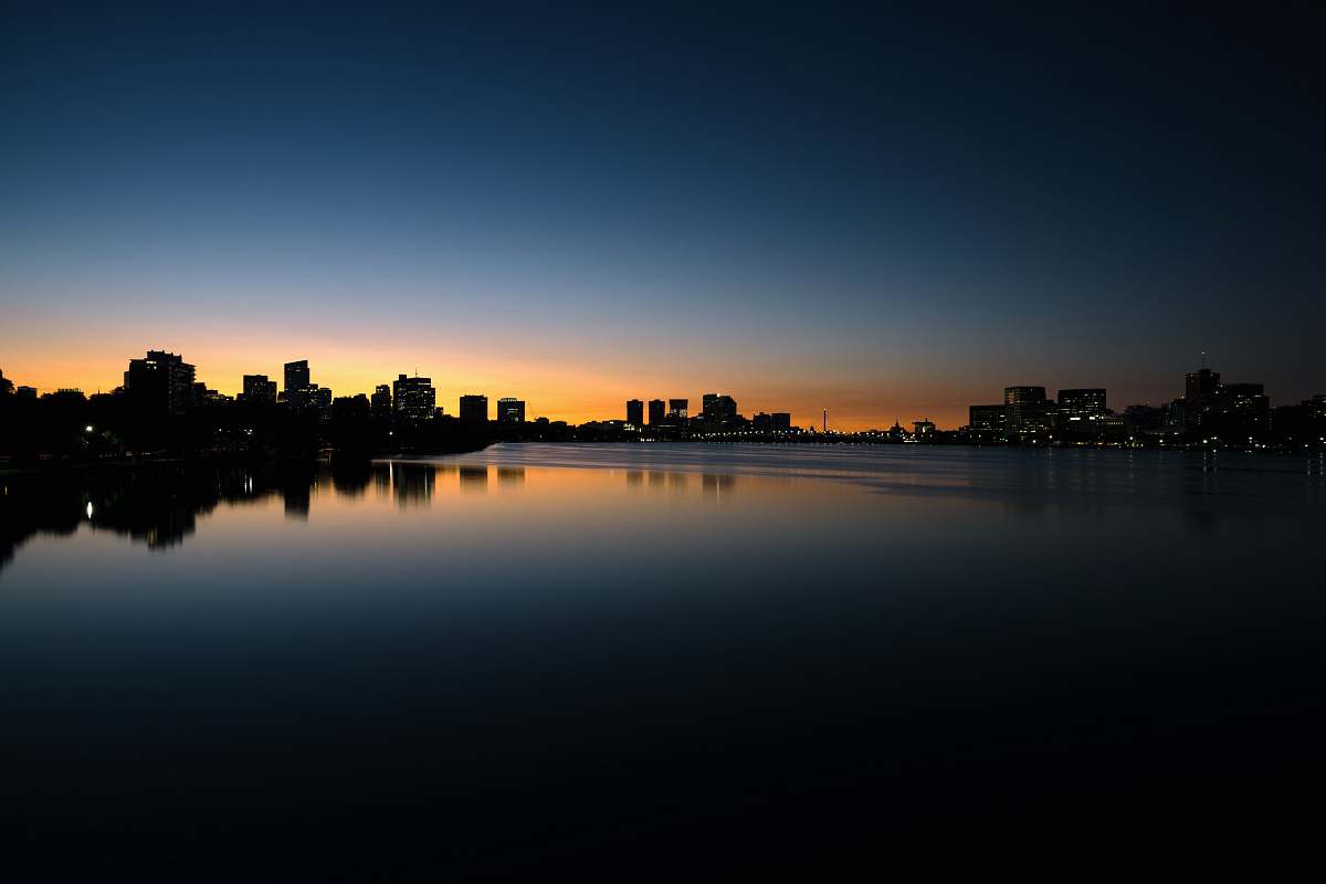 outdoors calm body of water near building sky