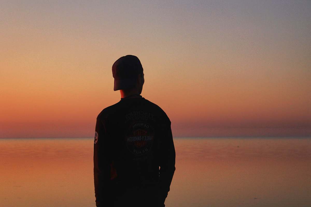 outdoors man in black sweatshirt dawn
