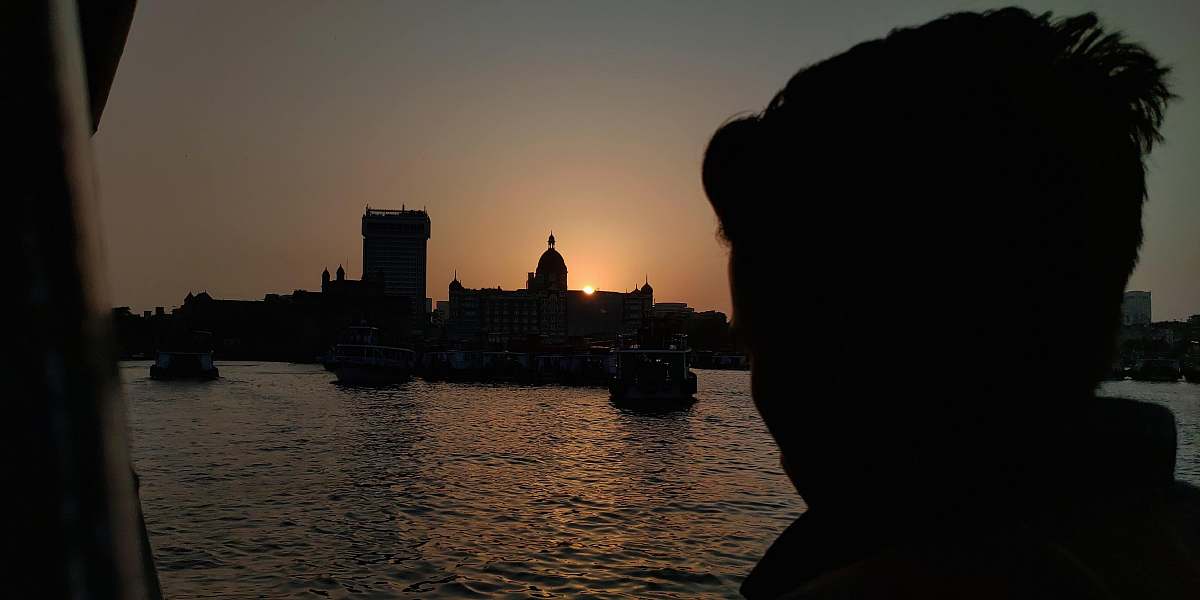 outdoors man looking at boats on sea sunlight