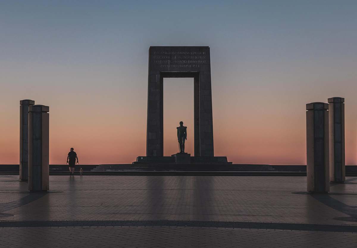 person person walking by monument during golden houre human