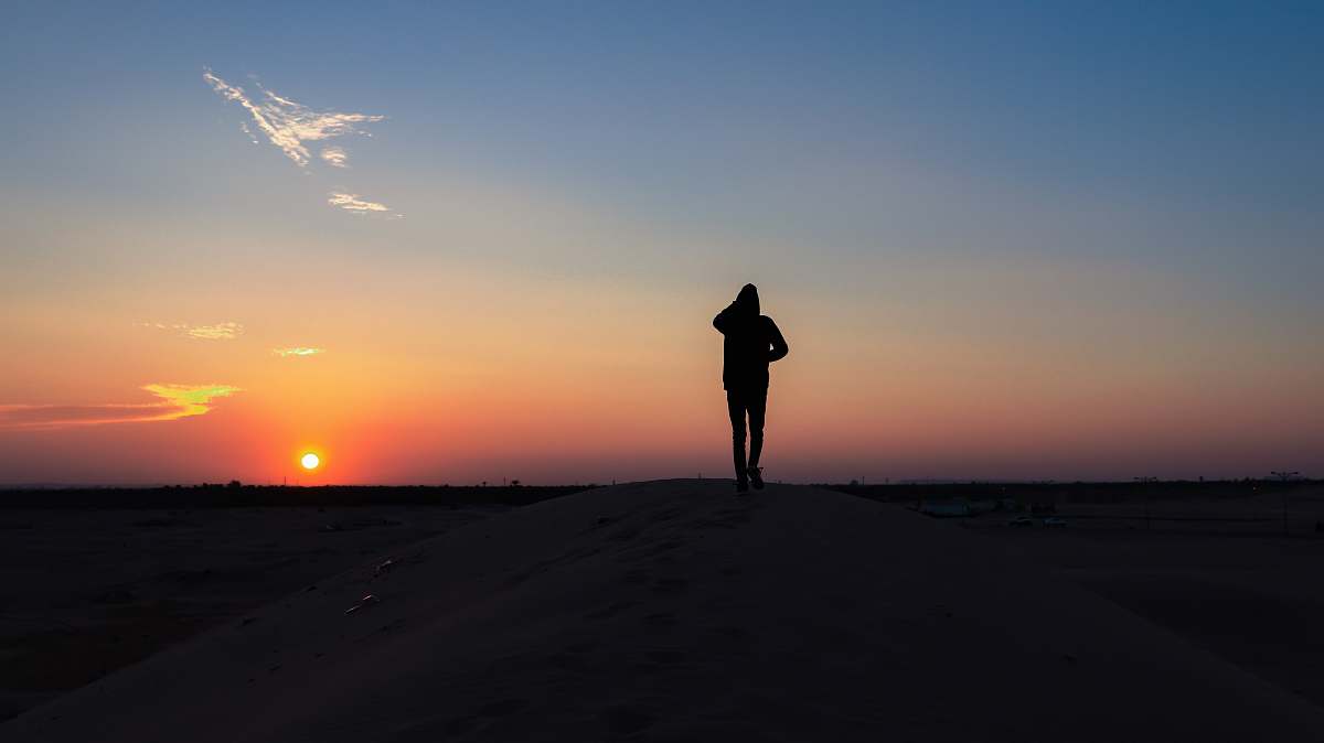 outdoors person walks on desert sky