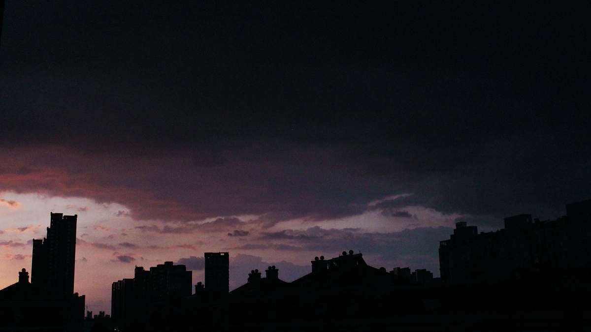 outdoors silhouette of building under cloudy sky during sunset weather