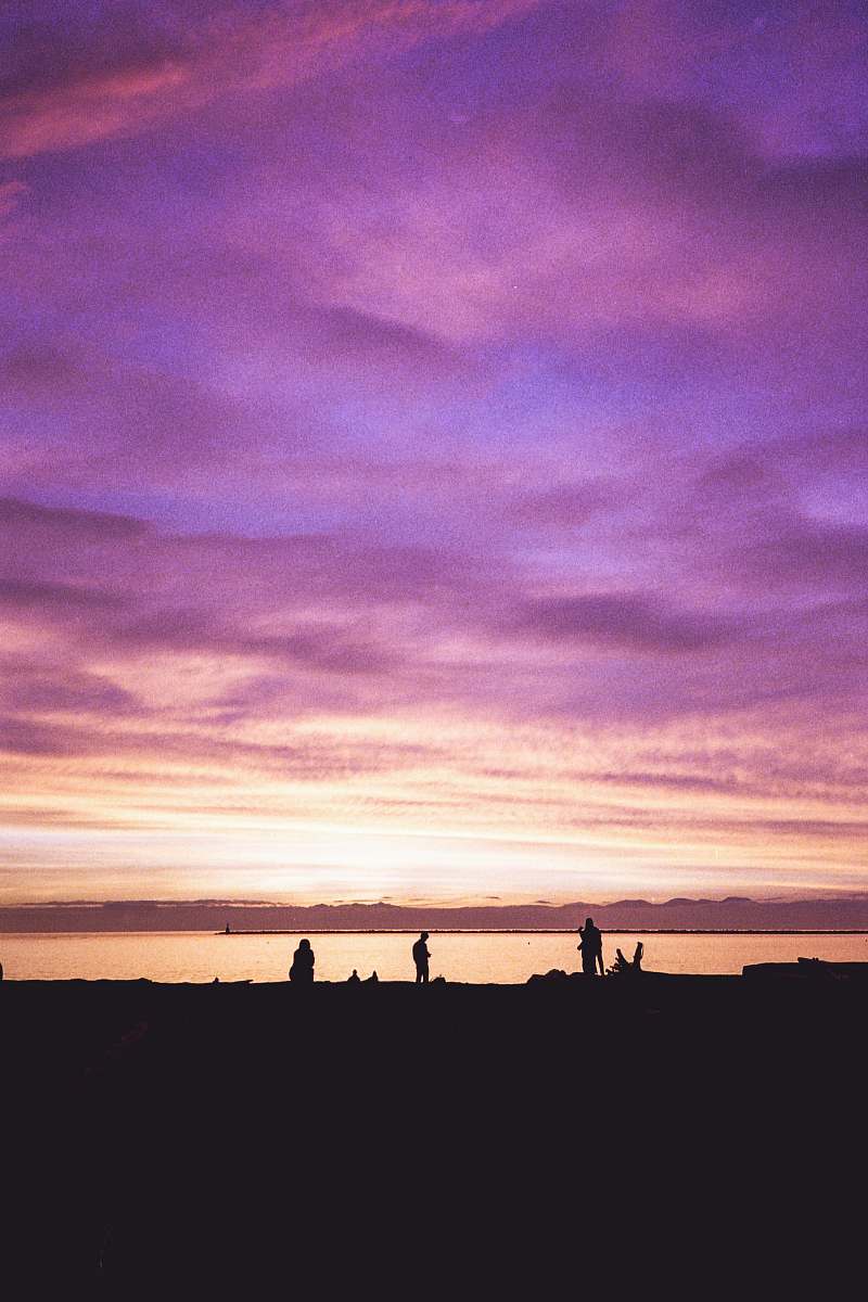 outdoors silhouette of person standing near body of water sunset