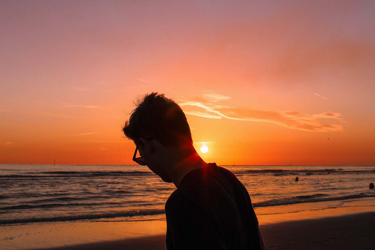 human silhouette photography of man on shore person