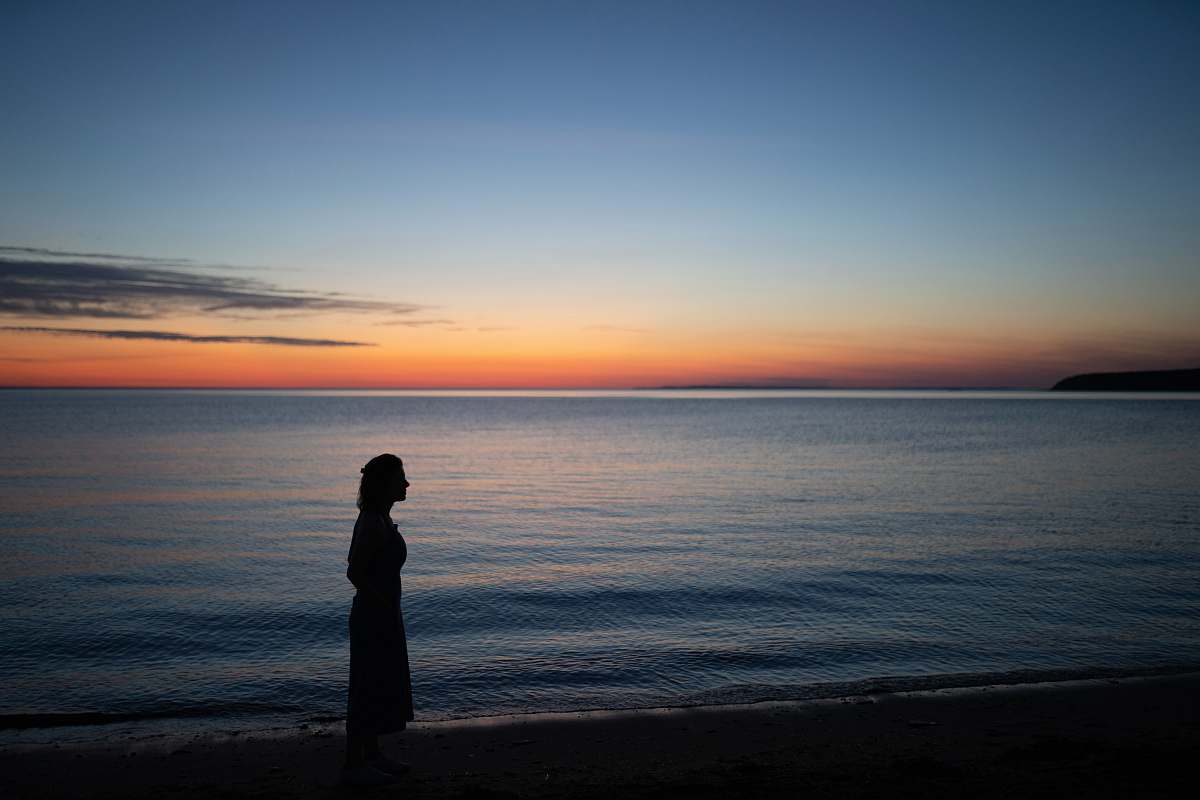 outdoors silhouette photography unknown person standing near body of water sea
