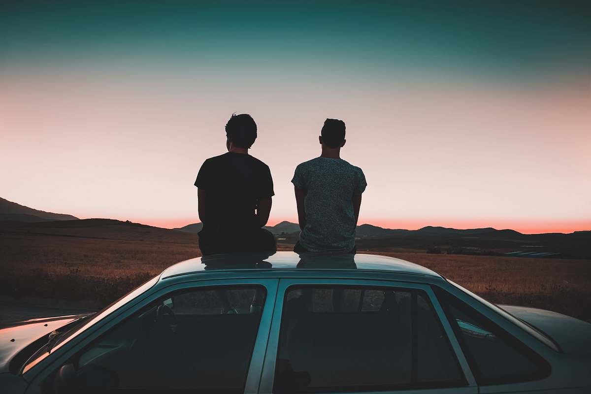person two men sitting on vehicle car