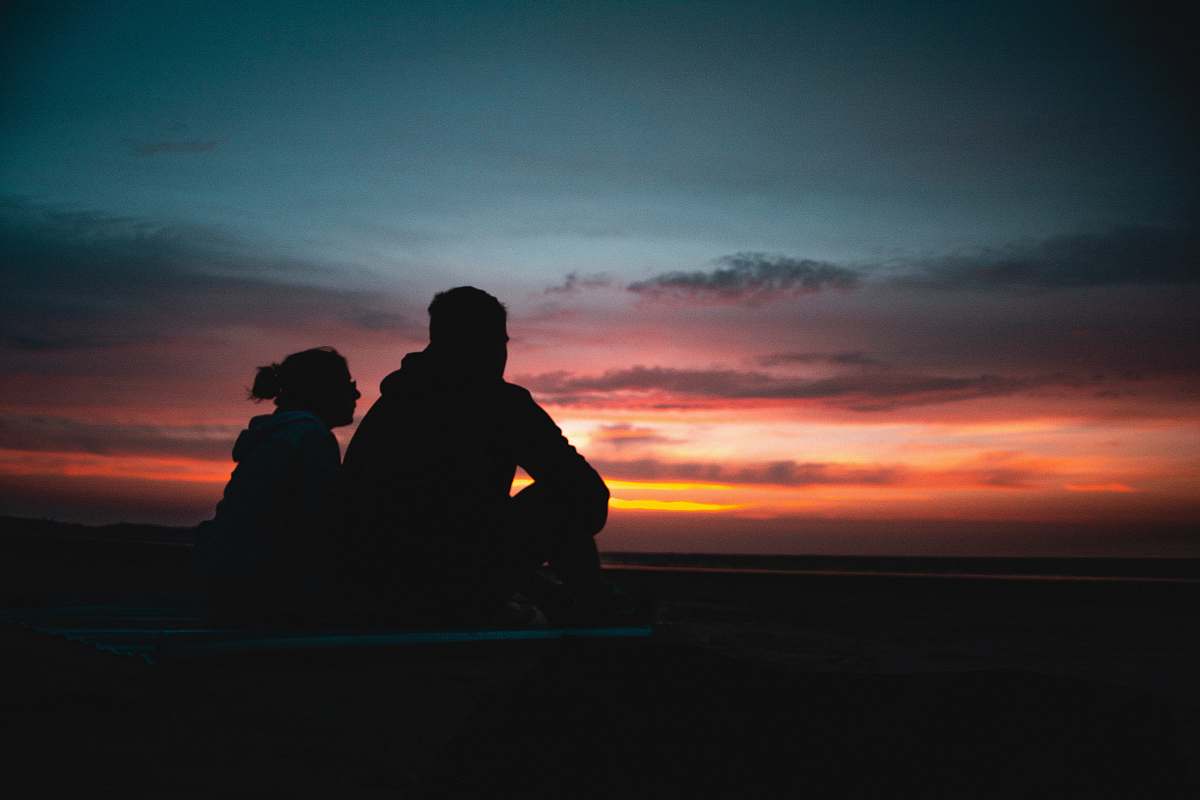 sunset two person sitting during golden hour sky