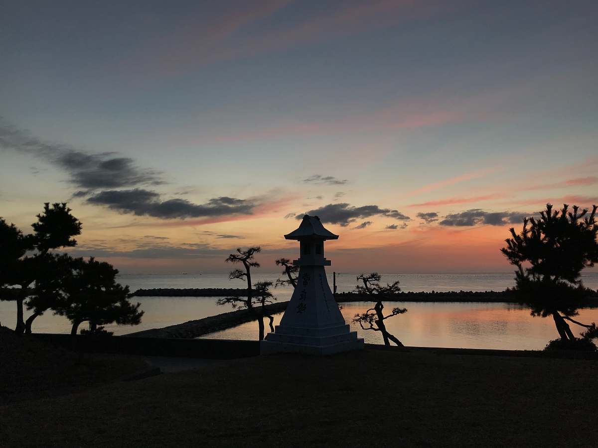 silhouette view of fish ponds during golden hour sunset