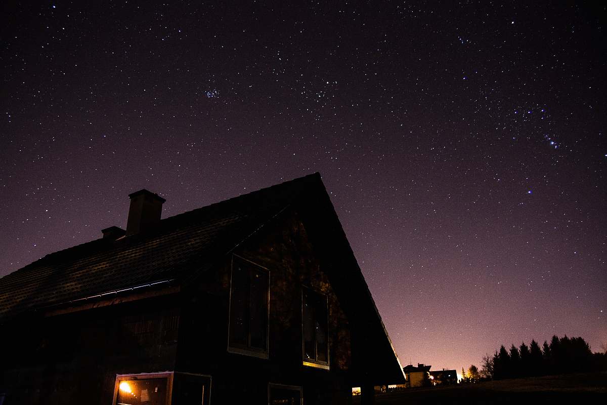 astronomy brown wooden house during nighttime space