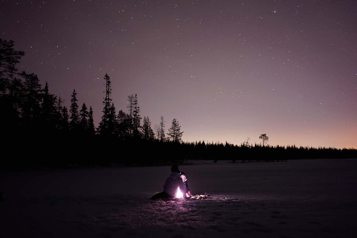 campfire person in front of bon fire during night family