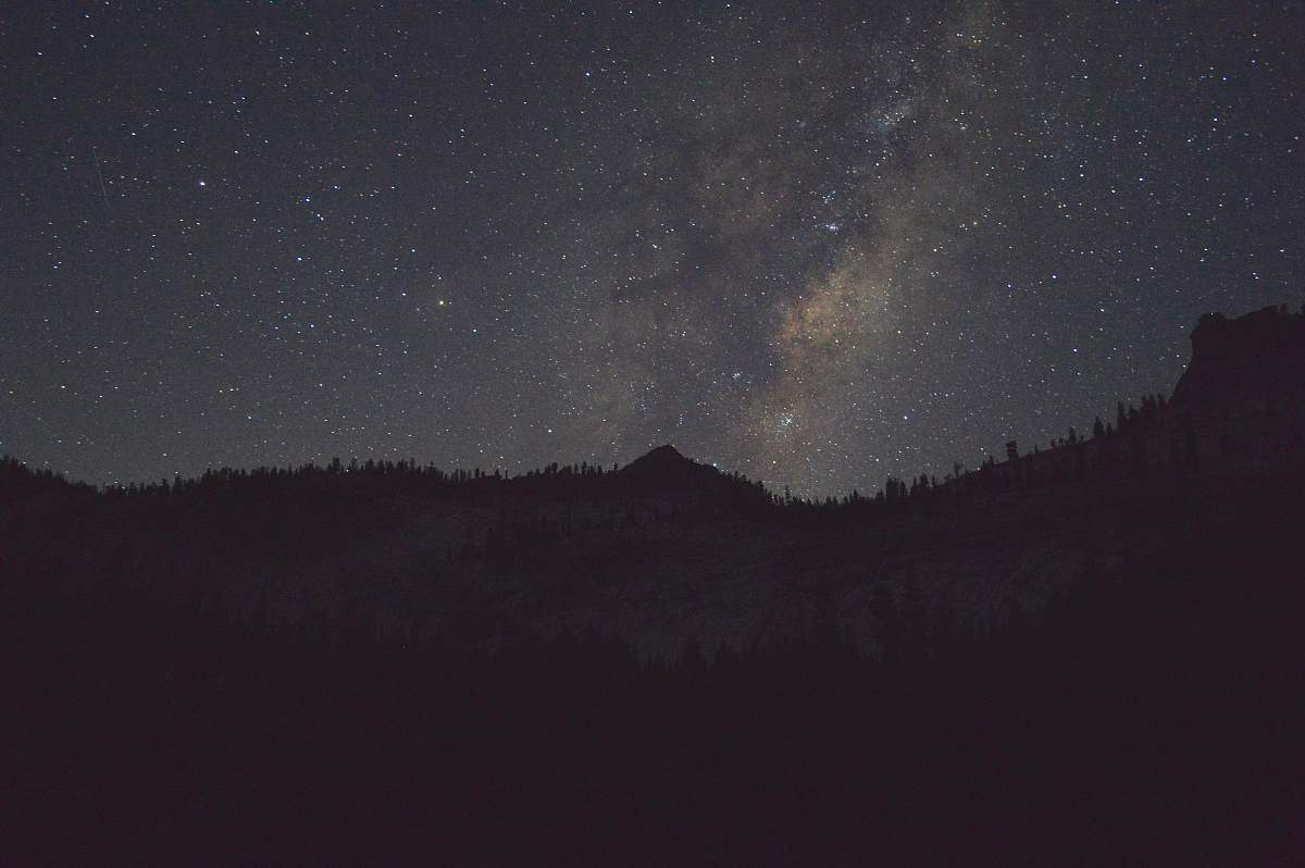 space silhouette of a mountain during night galaxy