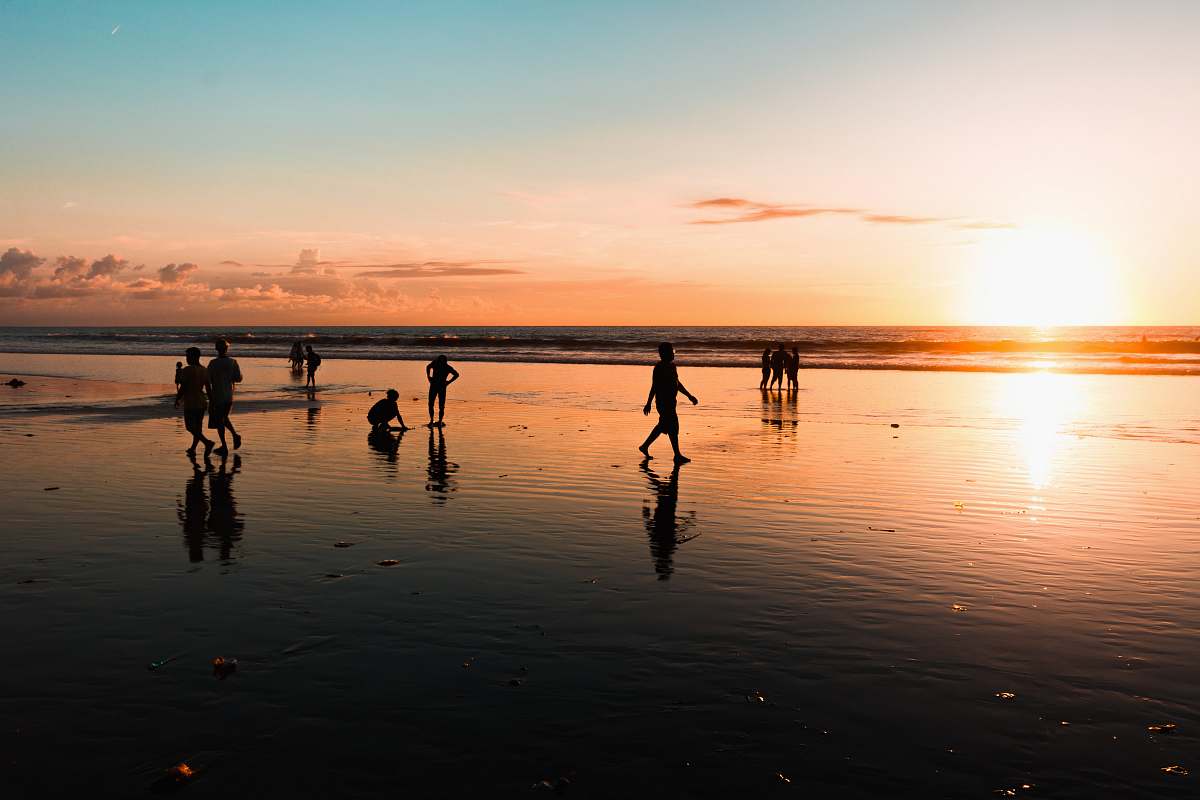 person people at the beach during golden hour human