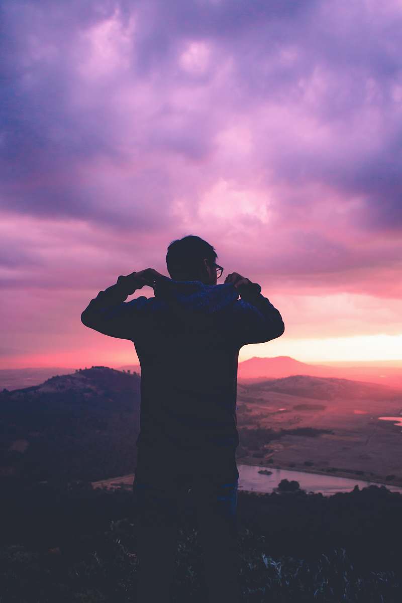 person A silhouette of a man looking out at a pink sunset and purple cloudy sky in Toluca, Mexico pink