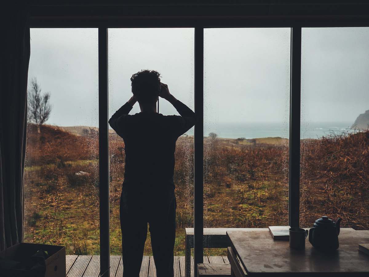 human man standing near glass window person