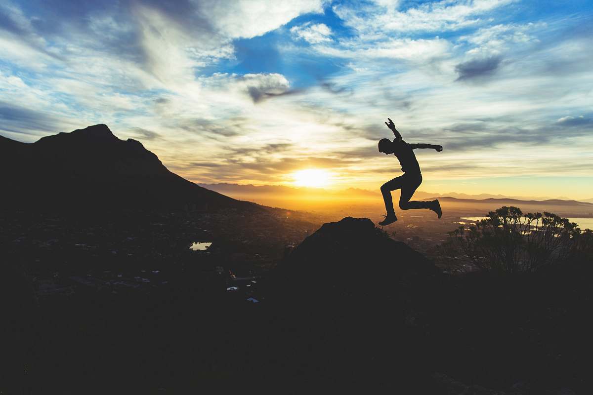 jump person jumping on hill during sunset jumping