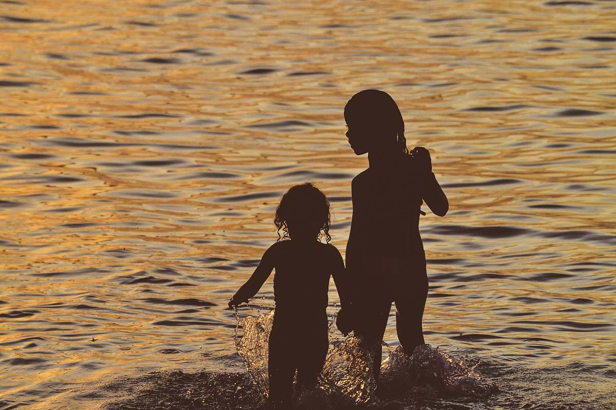 human silhouette of a girl running on the body of water person