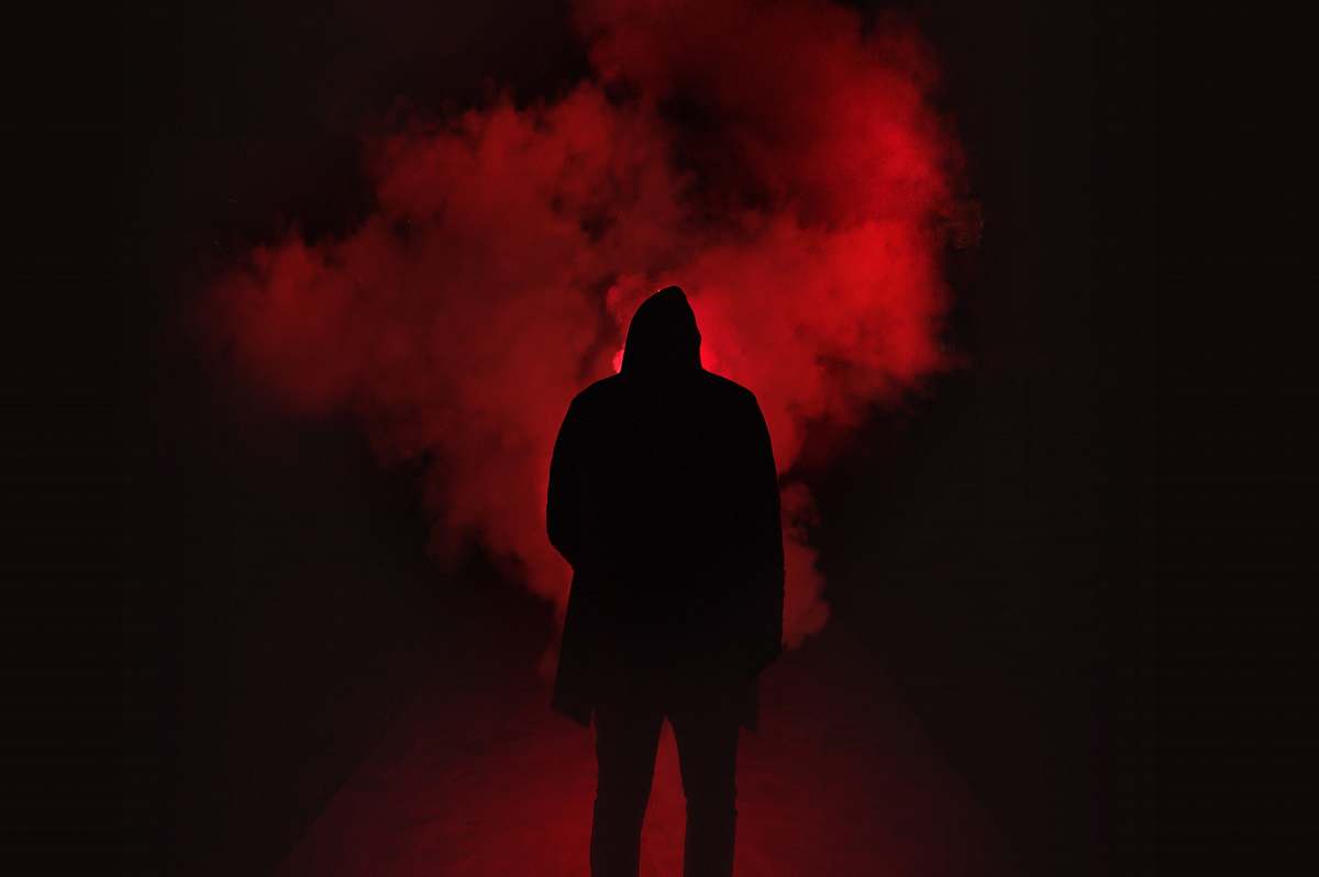 person silhouette of person on a dark place with smoke silhouette