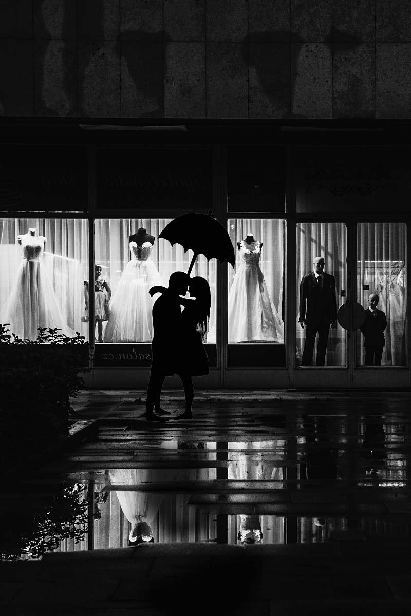 human man and woman stands near store black-and-white
