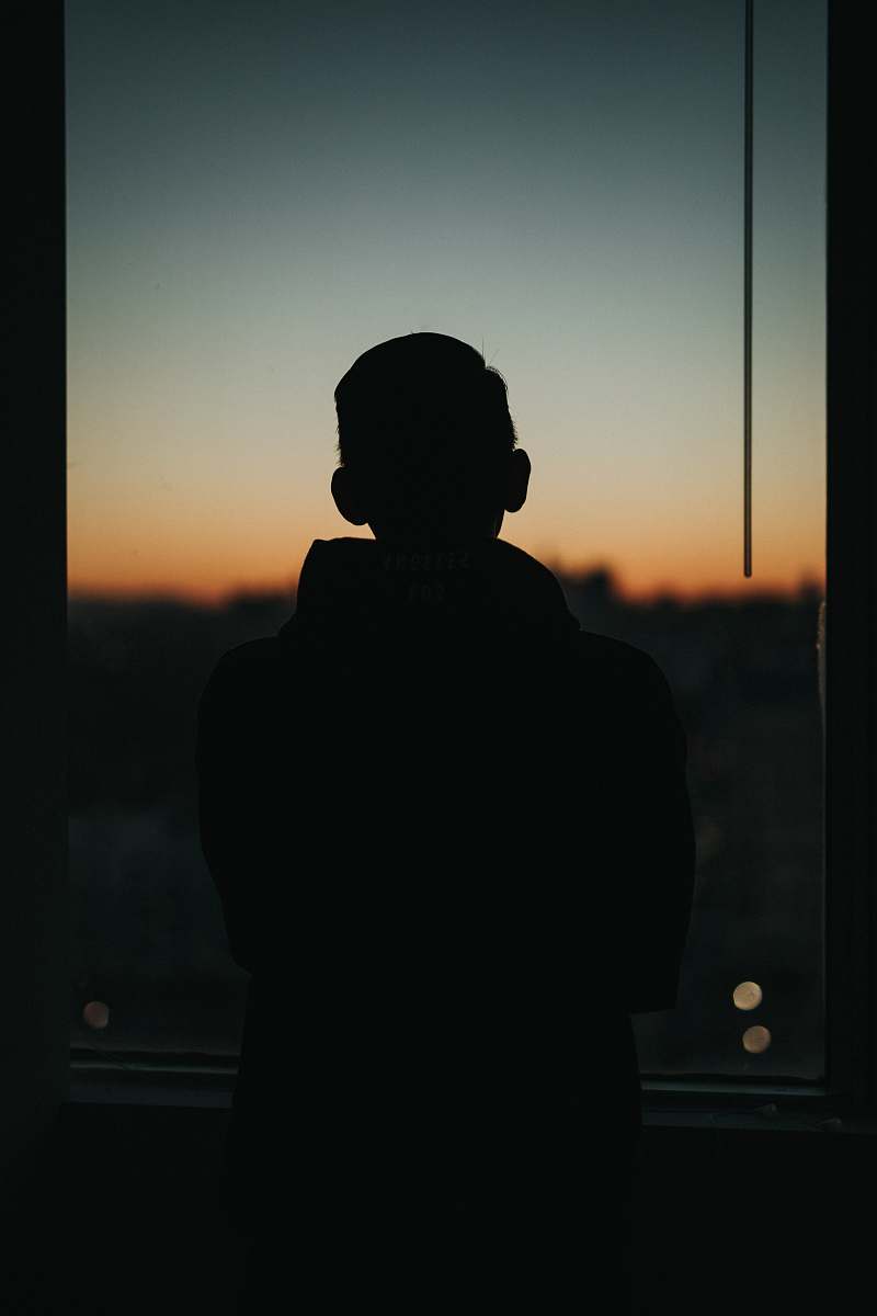 silhouette man standing front of glass window human