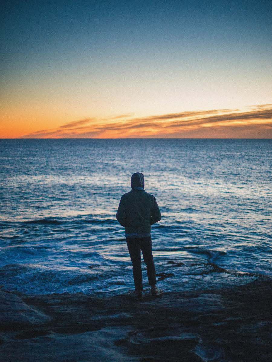 water man standing in front of body of water outdoors