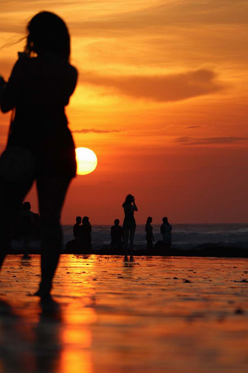 human people at the beach during golden hour sunset