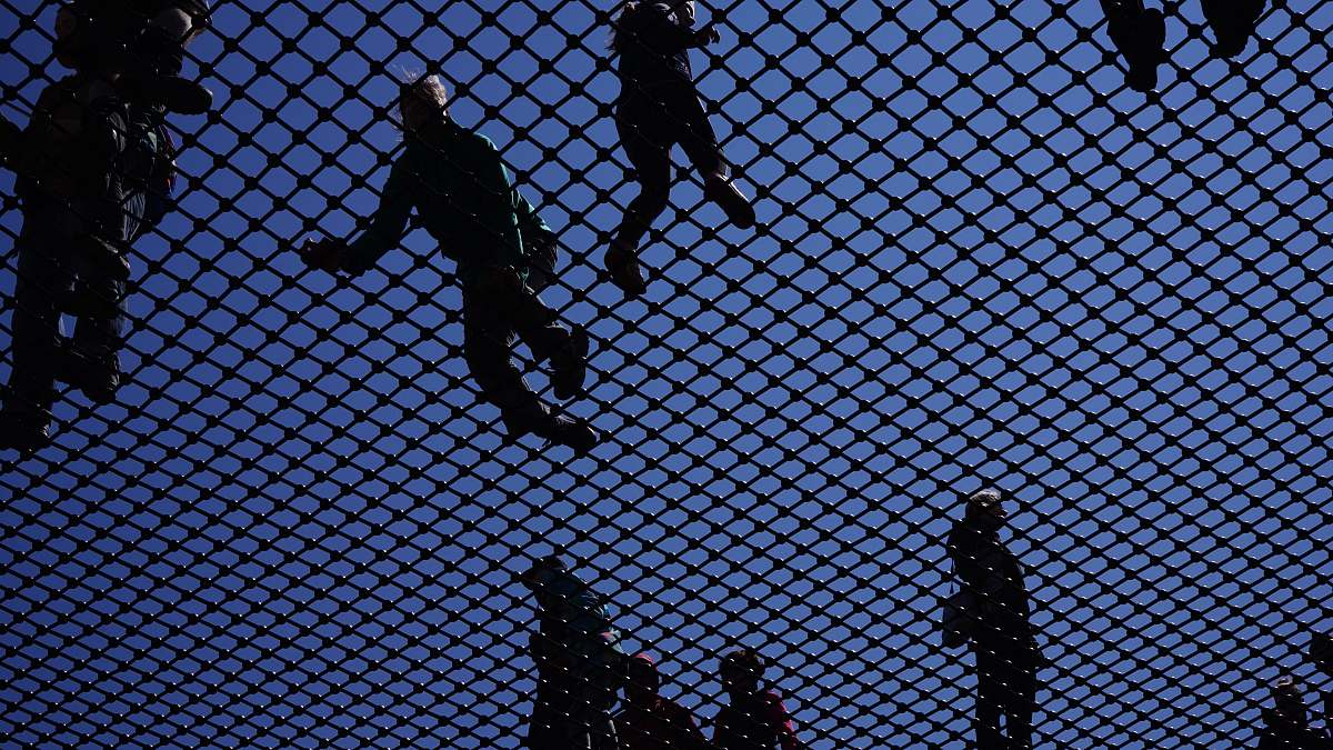 human people standing on gray metal screen during daytime water