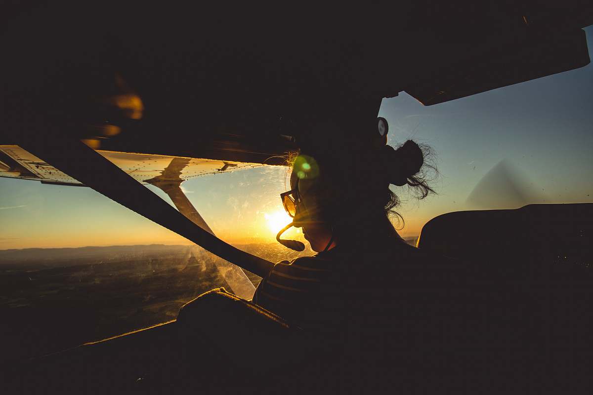 human person driving plane close-up photography silhouette