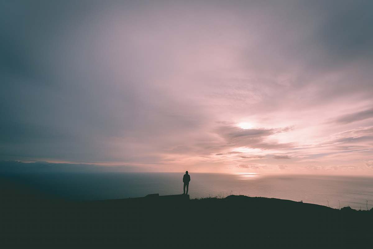 nature person standing on hill under gray sky outdoors