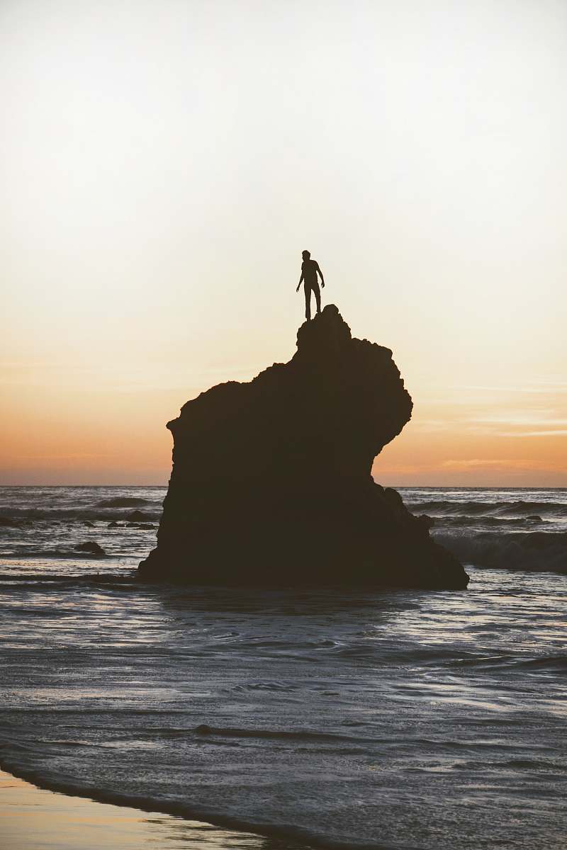 standing silhouette of a man on a rock human