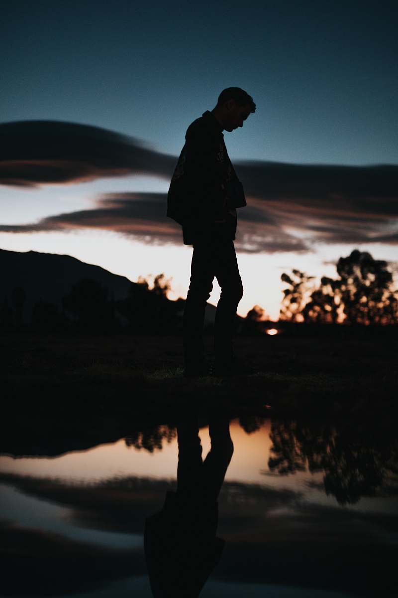 people silhouette of man near body of water human