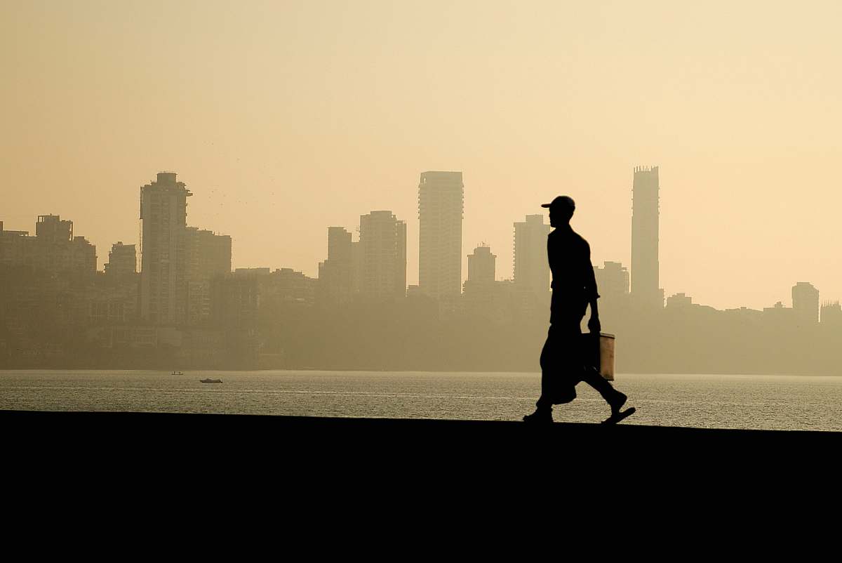 nature silhouette of man walking near the ocean human
