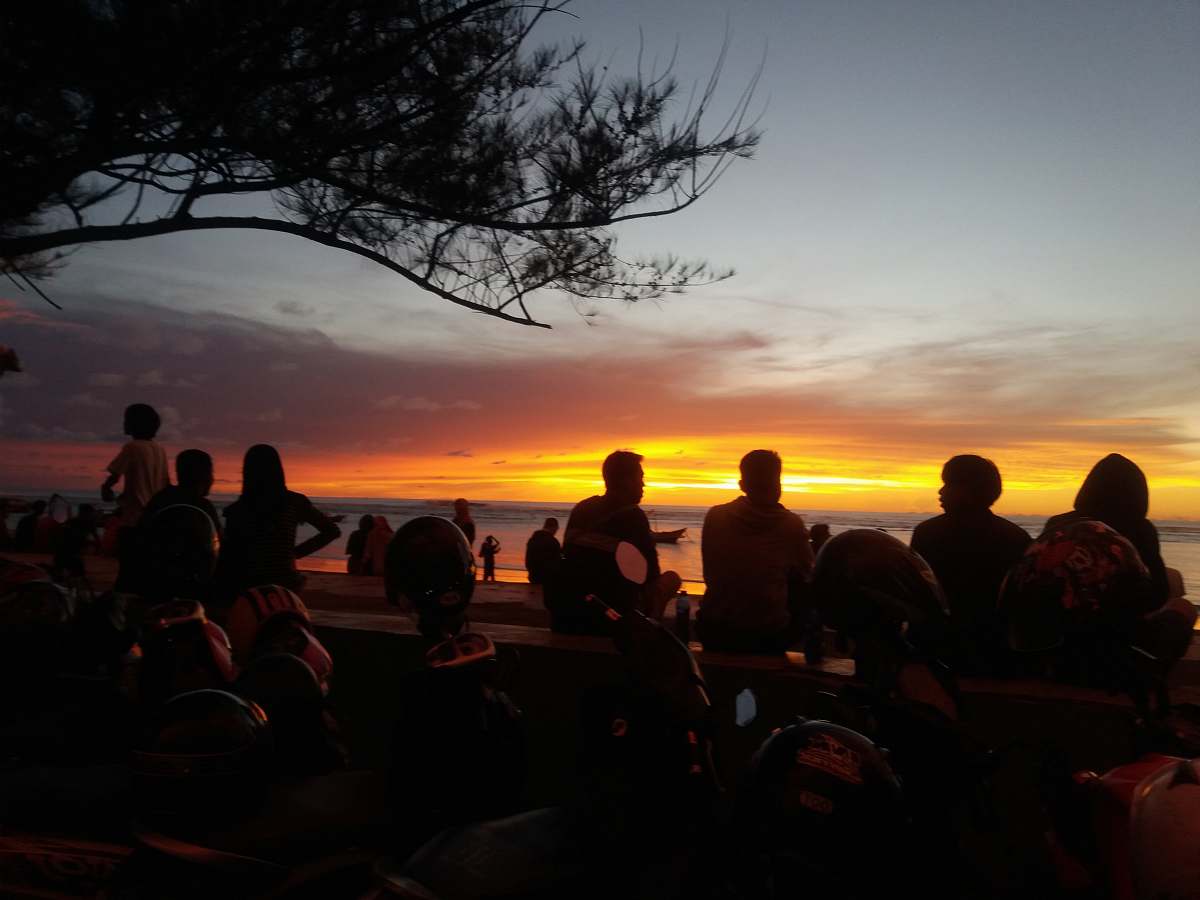 human silhouette of people facing body of water nature