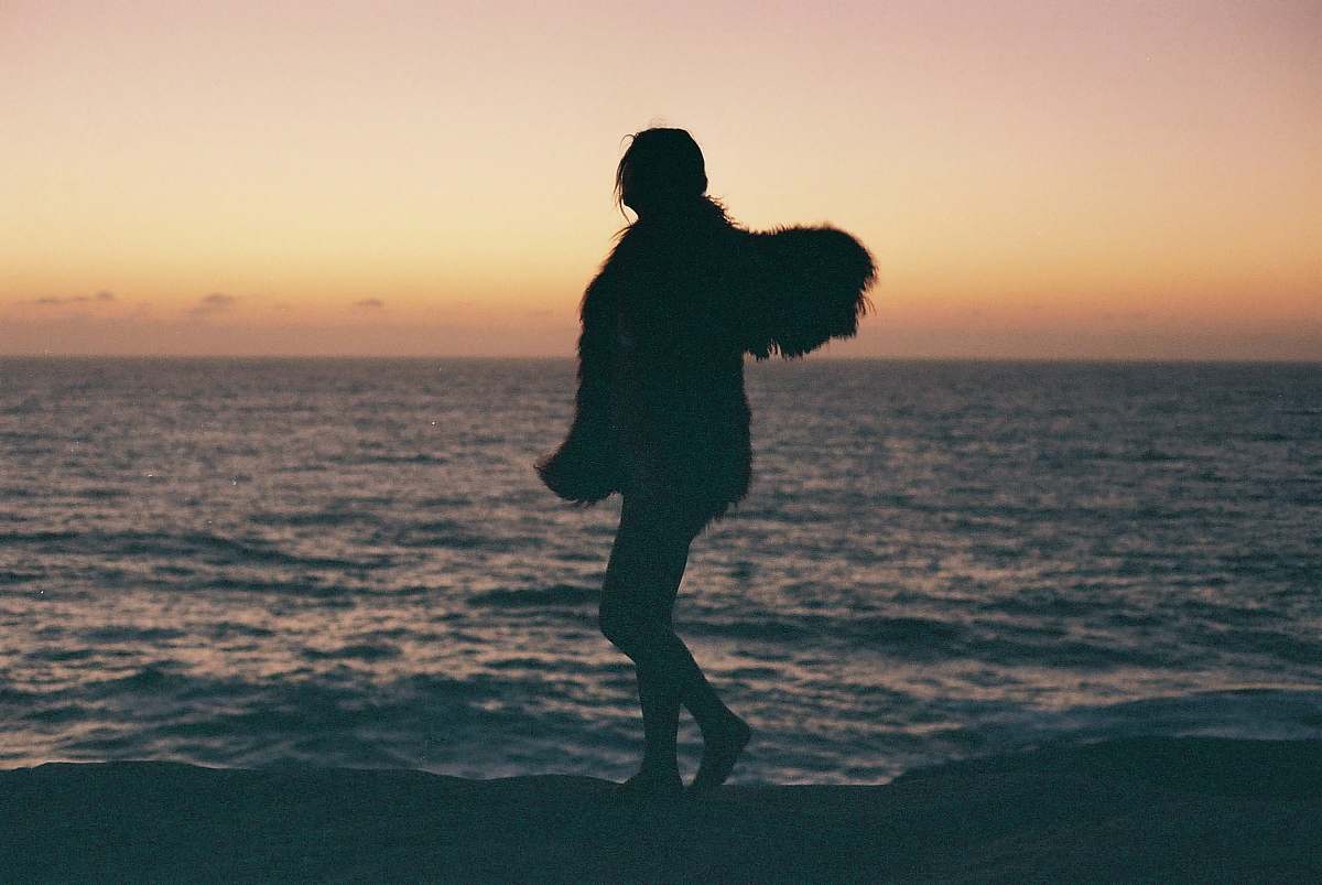human silhouette of person standing near seashore people