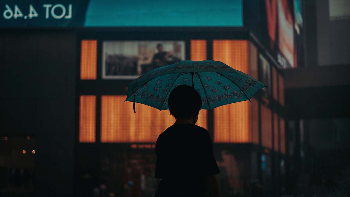 human silhouette of person under umbrella umbrella