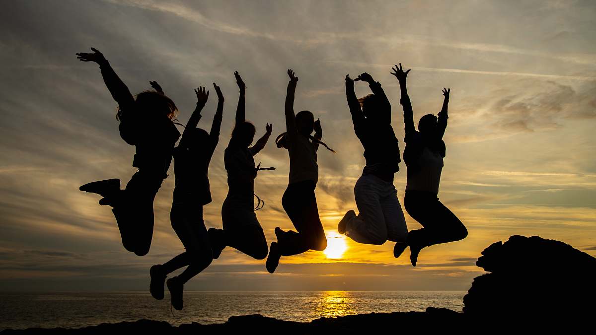 human silhouette of six women jumping beside seashore silhouette