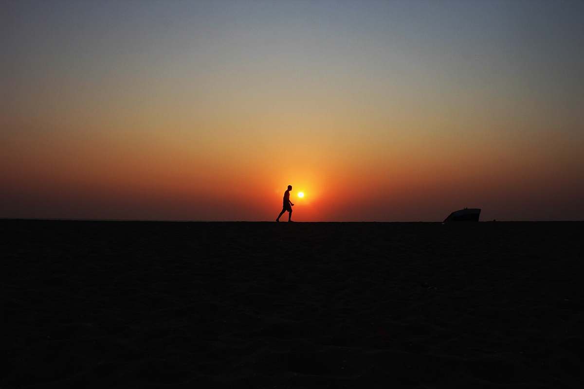 sunrise silhouette of walking man under sunset sunset