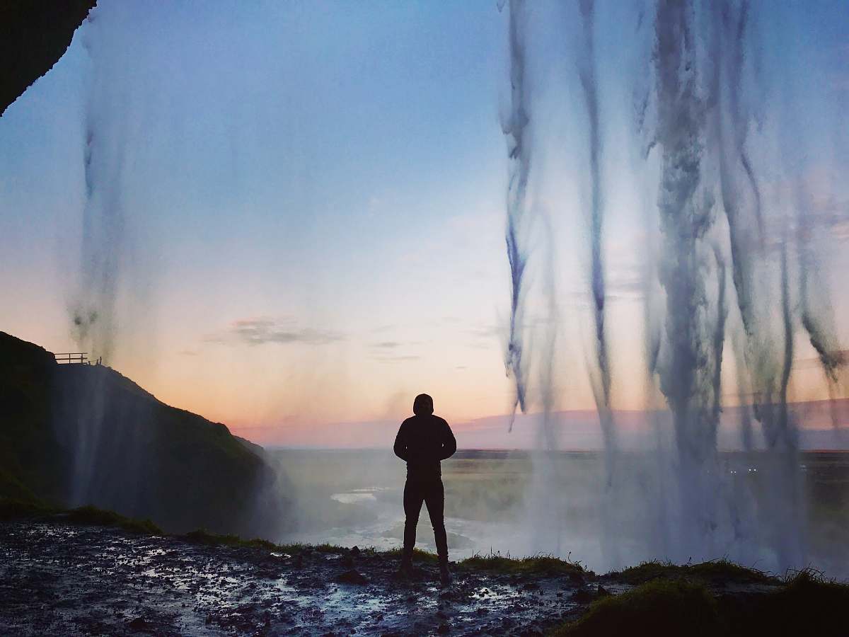 human silhouette on man standing near body of water people