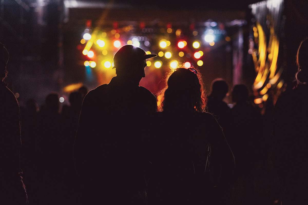 silhouette silhouette photo of a man and a woman on the stage outdoors