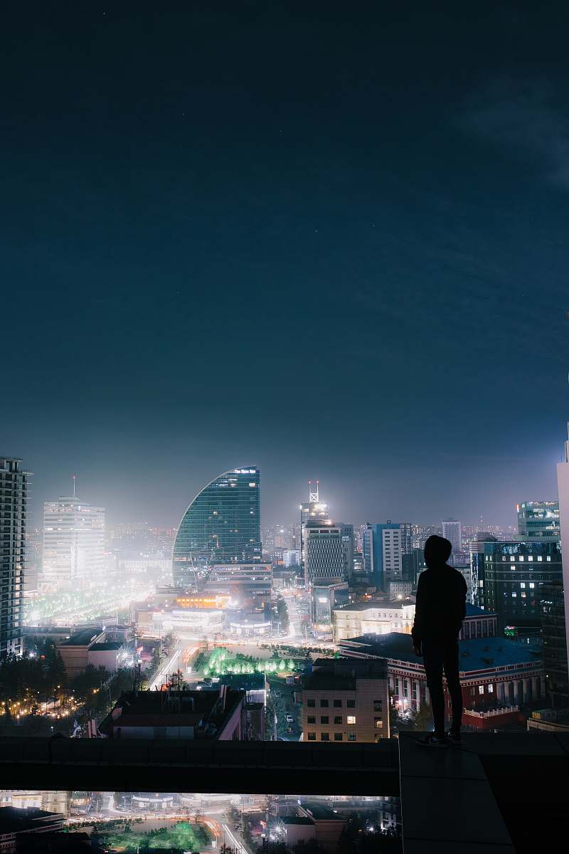 human silhouette photo of a person on the top of a building people