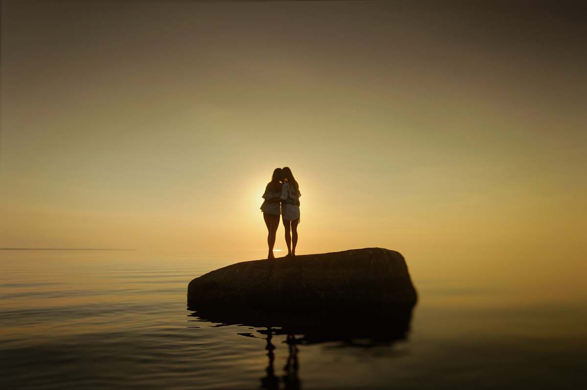 human two women on rock standing