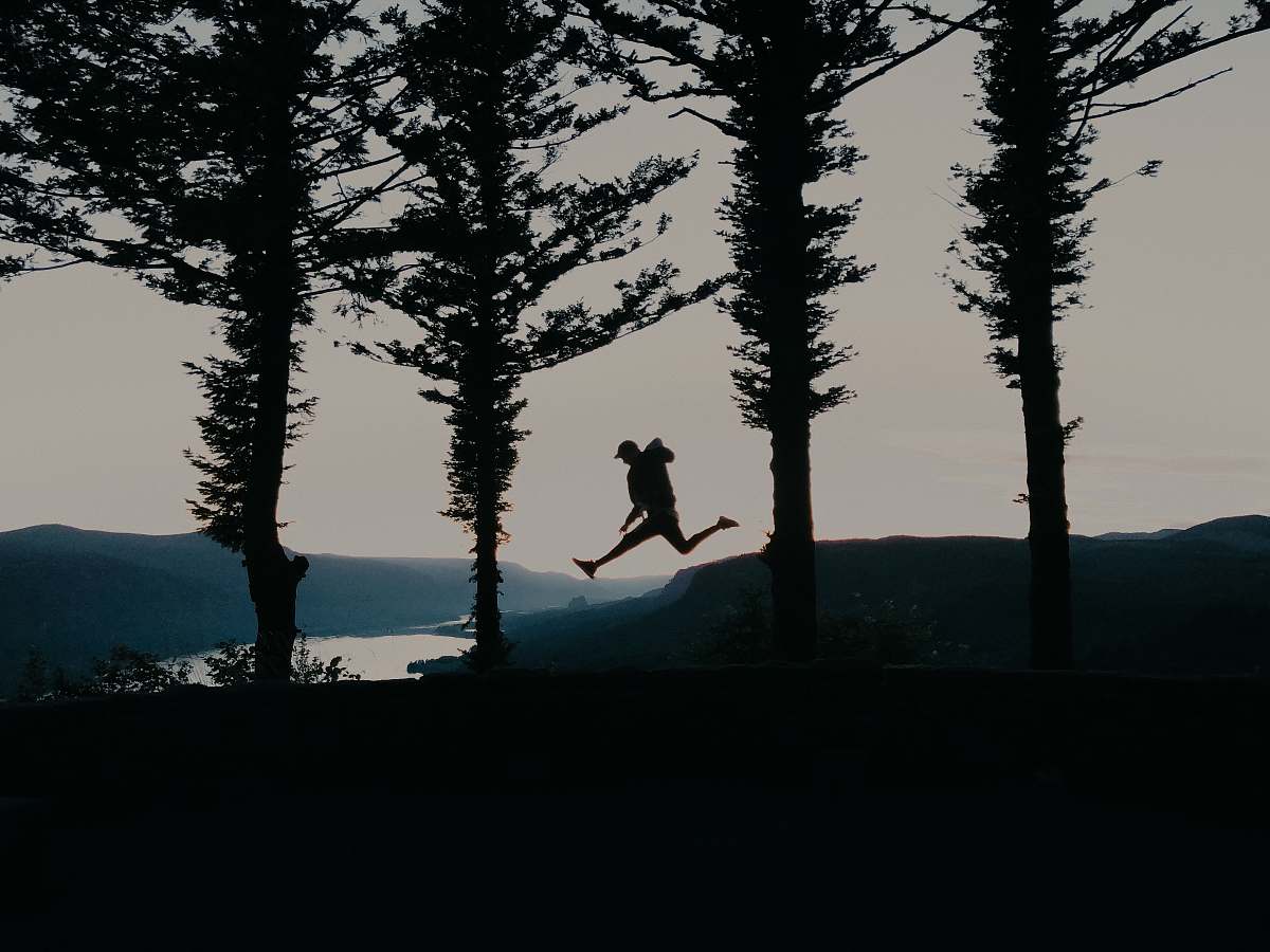 tree leaping person by trees silhouette abies